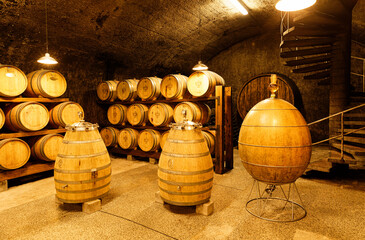Dobrovo, Slovenia -  July 19 2020: Constant temperature arched cellar with French barrique oak barrels to age wine at Klet Brda. - obrazy, fototapety, plakaty