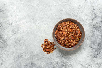 Homemade granola in a bowl on a gray grunge background. View from above.