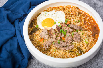 A basin of Korean instant noodles on a white background