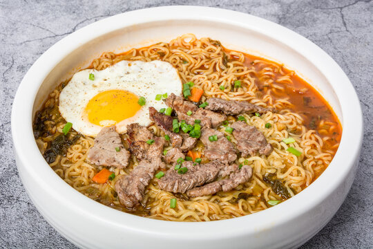 A basin of Korean instant noodles on a white background