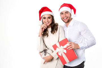 Joyful loving couple in Santa hat with gifts in hands isolated on white