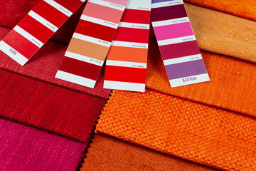 Fototapeta na wymiar red and orange textile samples with colors palette