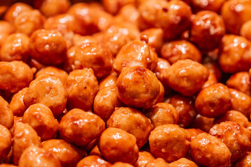 Caramelized peanuts with honey and sugar in the Boqueria market in Barcelona (Spain).