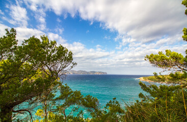 Fototapeta na wymiar Seascape of the Mediterranean Sea at Alcúdia peninsula with clouds and blue sky, Mallorca island, Balearic islands, Spain, Europe