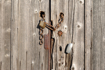 Close Up of Padlock and Rusty Chain ol Old Wooden Gate 