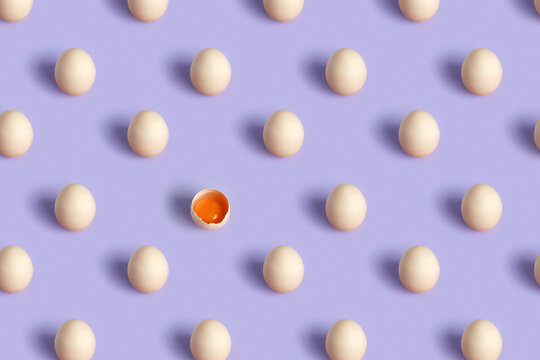 A pattern of eggs on a purple background, one broken egg.