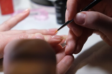 manicurist job done perfectly well the customer is satisfied with beautiful manicured hands