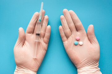 Vaccination, immunization, disease prevention concept. Pills or syringe choice. 