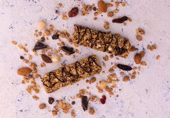 Granola bars with chocolate on a white textured background. Flat lay.