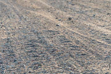 The texture of the earth. View of a flat agricultural field after harvesting. Dry lifeless surface without vegetation. Blank background for design or text insertion.