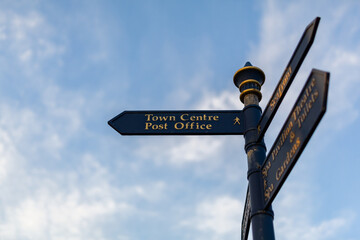 Town centre sign in a popular British seaside tourist destination, it is isolated against a blue sky with light clouds