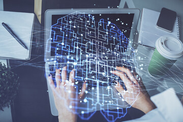 Double exposure of woman hands working on computer and brain hologram drawing. Ai concept.