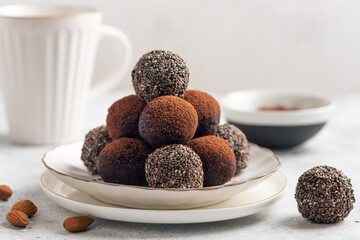 healthy energy balls with chia seeds, cocoa powder on white background. vegan alternative food. closeup