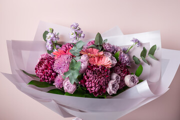 Beautiful bouquet with chrysanthemums, roses, gerbera daisies on pink background. Color of the year...