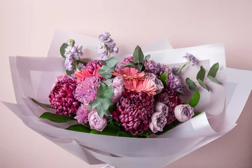 Selbstklebende Fototapeten Beautiful bouquet with chrysanthemums, roses, gerbera daisies on pink background. Color of the year 2022. Veri peri © Mila Naumova