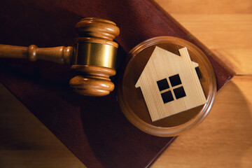 House model with gavel on law books