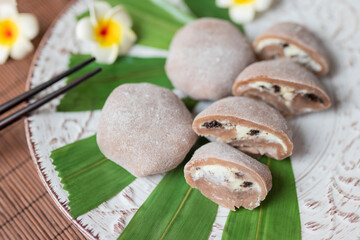 delicious japanese cuisine dessert mochi cakes with butter cream and chocolate with bumbuka leaves