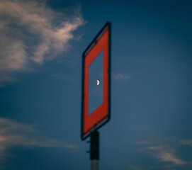 limit sign on blue sky with moon shining through