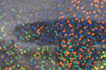 detail macro photo of silver rainbow holographic dot foil material, colorful hologram surface.