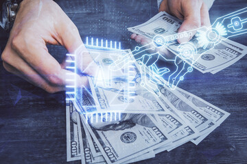 Multi exposure of technology drawing hologram and us dollars bills and man hands. Data concept