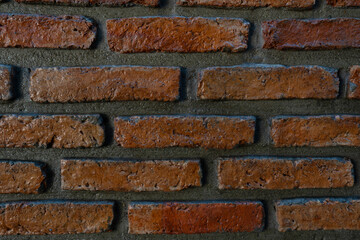 Texture of old dark brown and red brick wall background. Close-up