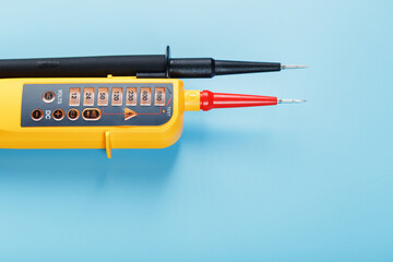 Yellow tester for step-by-step indication of voltage in an electrical circuit on a blue background