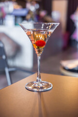 Cocktail alcohol with red cherry on table in resturant.