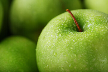 Juicy Green apple close-up with dew drops.