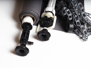 roll and fastening system of paper gray background. weight and gear with plastic chain