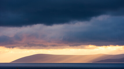 Sunlight and sea seeping through the clouds