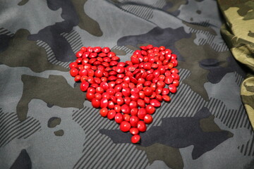 red heart shape of Adenanthera pavonina with camouflage color design for love and passion of...