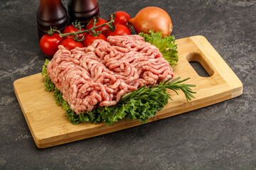 Raw pork minced meat over board