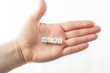 hope concept word from cubes in human hand