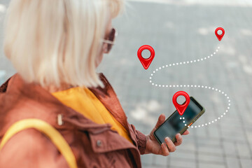 Woman using smart phone with navigation app at street background