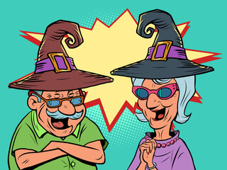 An old man and an old women couple in halloween hats laugh. love and friendship