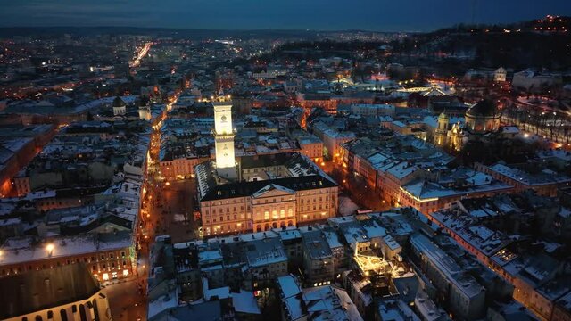 Panorama of the ancient city. City Council, Town Hall, old church Lviv Latin Cathedral. The roofs of old buildings. Aerial, drone view. Winter night. lviv, ukraine