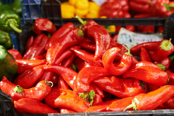 Red fresh peppers on the counter in a vegetable shop. High quality photo