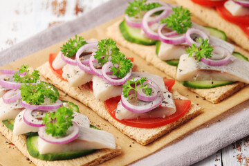 Sandwiches with herring and vegetables