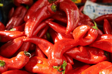 Red fresh peppers on the counter in a vegetable shop. High quality photo