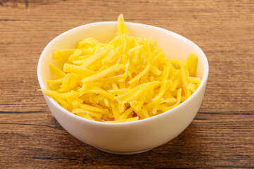 Shredded yellow cheese in the bowl