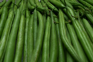 Close-up of fresh green beans lined up. Immature pods of common beans. Vegetable for vegetarian. Food for vegan.	