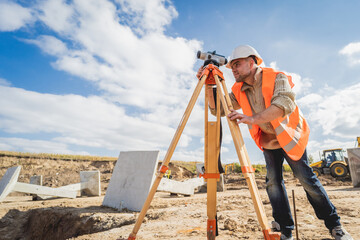 Surveyor worker with theodolite equipment at construction site