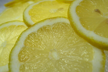 Lemon slices lined up close-up. Acid citrus fruit arranged for backgrounds.