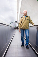 Fototapeta na wymiar European old man going down to subway