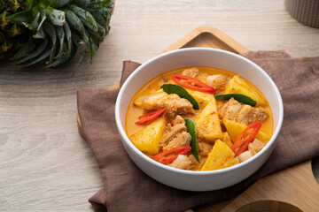 Thai Red curry Pineapple with Sliced Pork Belly in white bowl