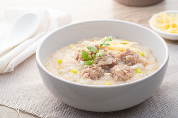 Close up Rice porridge ,congee with minced pork and ginger in white bowl