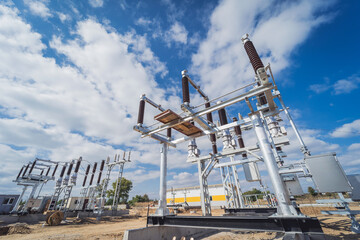 Fototapeta na wymiar Construction of a power transmission substation on a background of blue sky