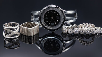 Elegant women's watches in a metal case and jewelry made of silver