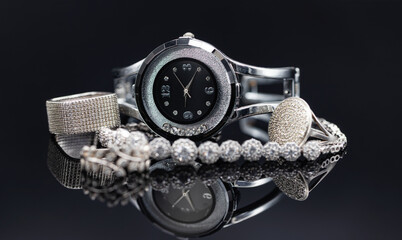 Elegant women's watches in a metal case and jewelry made of silver