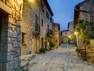 Street with stone houses of the beautiful town of Siurana at dusk, Province of Tarragona 